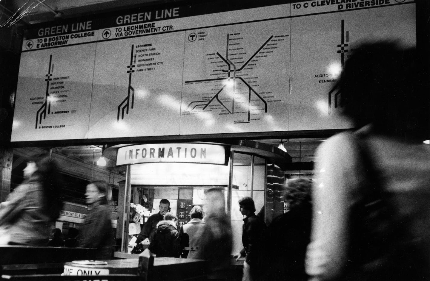 Dick Donahue and Bob O'Neil work at the information booth at the MBTA's Park Street Station in Boston on Dec. 6, 1974.